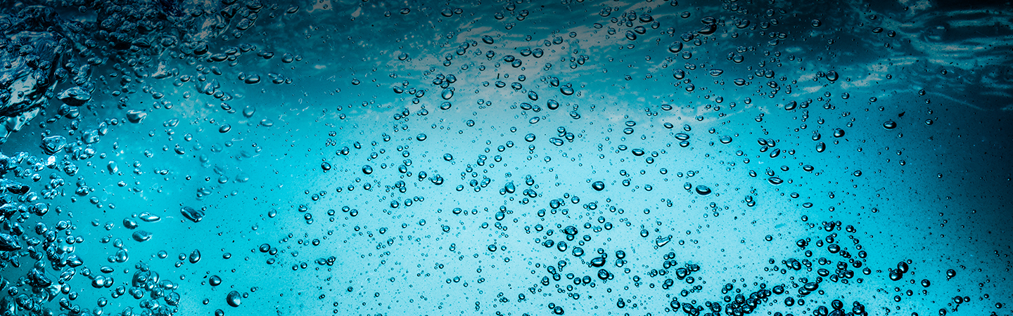 Many bubbles in water close up, abstract water wave with bubbles