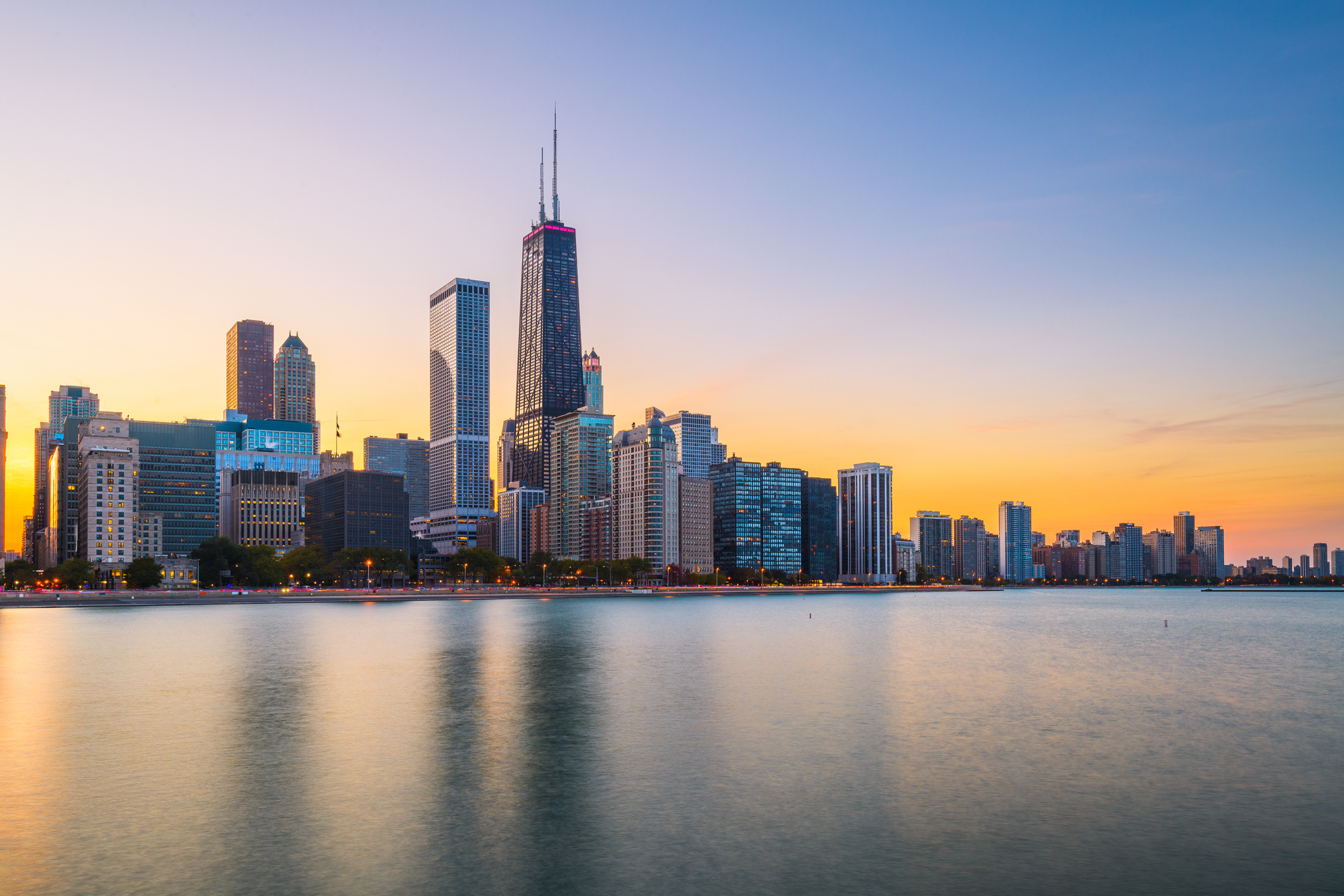Chicago skyline at sunset reflected on Lake Michigan