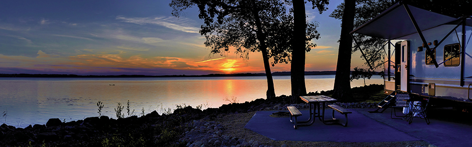 RV by water at sunset; Adobe Stock: 361874372