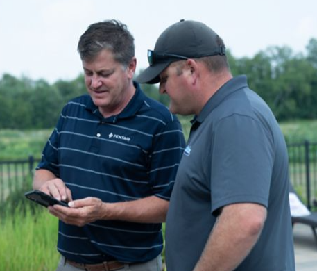 Two men looking at a phone