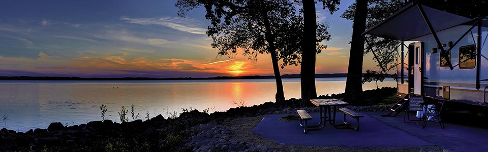 RV by water at sunset; Adobe Stock: 361874372